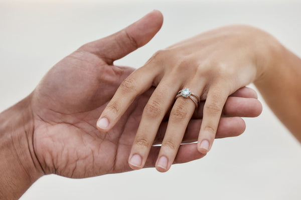 Marriage jewellery and wedding ring with hands.