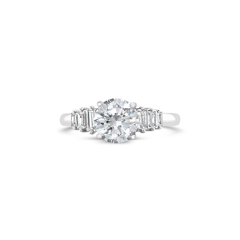 white gold engagement ring with emerald cut side diamonds