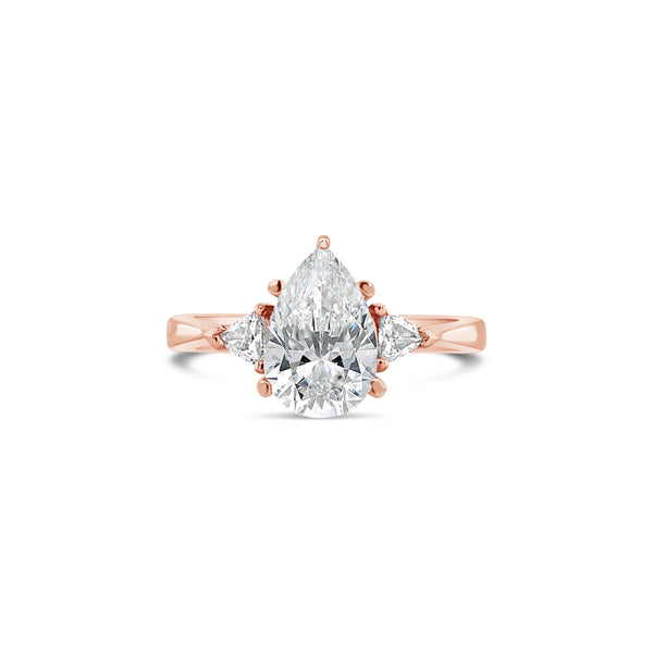 Pear cut diamond engagement ring with trillion side diamonds